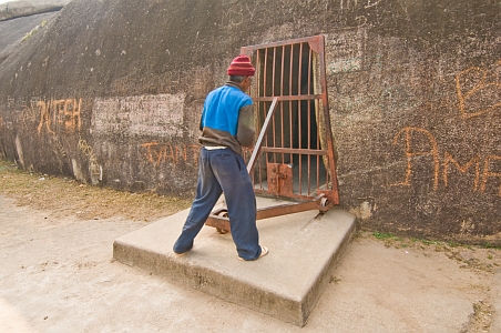 Locking the entrance to the Karan Chopar cave - Click to show bigger image in new browser