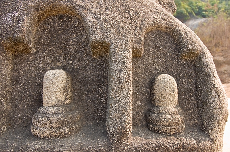 Carved Shiva lingams on rock surfaces - Click to show bigger image in new browser