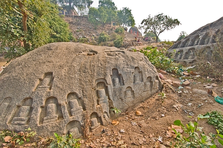 Carved Shiva lingams on rock surfaces - Click to show bigger image in new browser