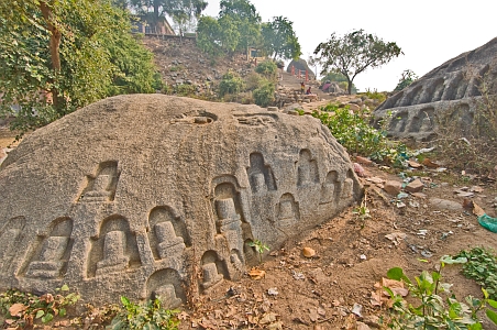 Carved Shiva lingams on rock surfaces - Click to show bigger image in new browser