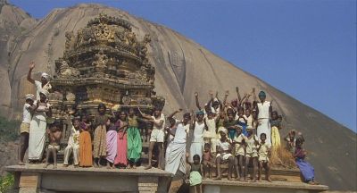 Waving locals on the Roof of a Small Temple - Click to show full-size image in new browser